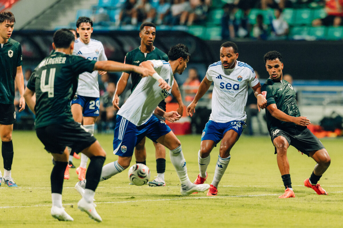 Lion City Sailors and Tanjong Pagar United players challenge for the ball in the penalty area