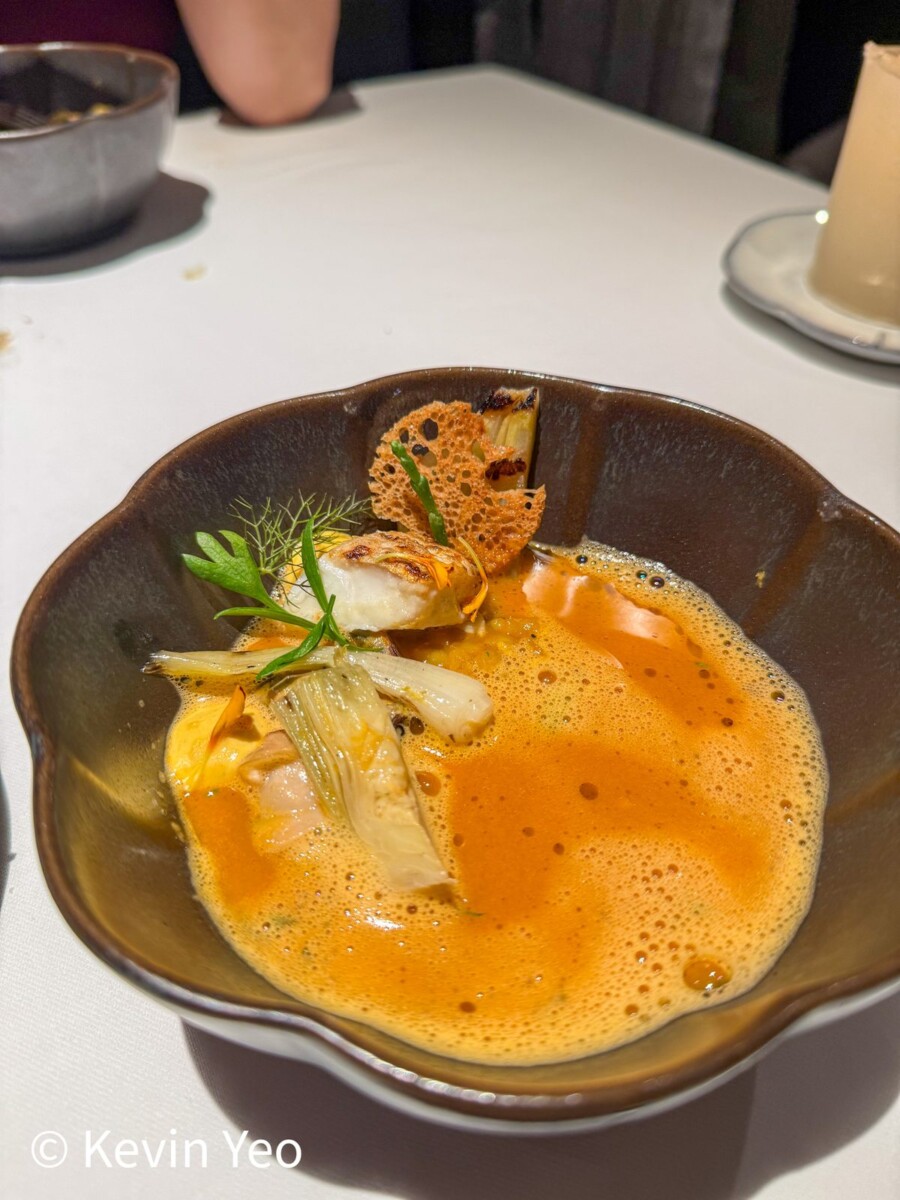 Le Pristine Singapore signature fish soup with prawn clam and squid in a saffron broth