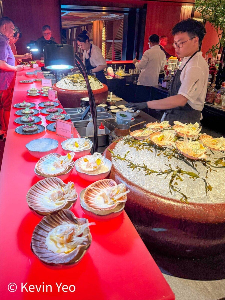 Seafood station at Le Pristine Singapore with scallop crudo on shells and oysters on crushed ice