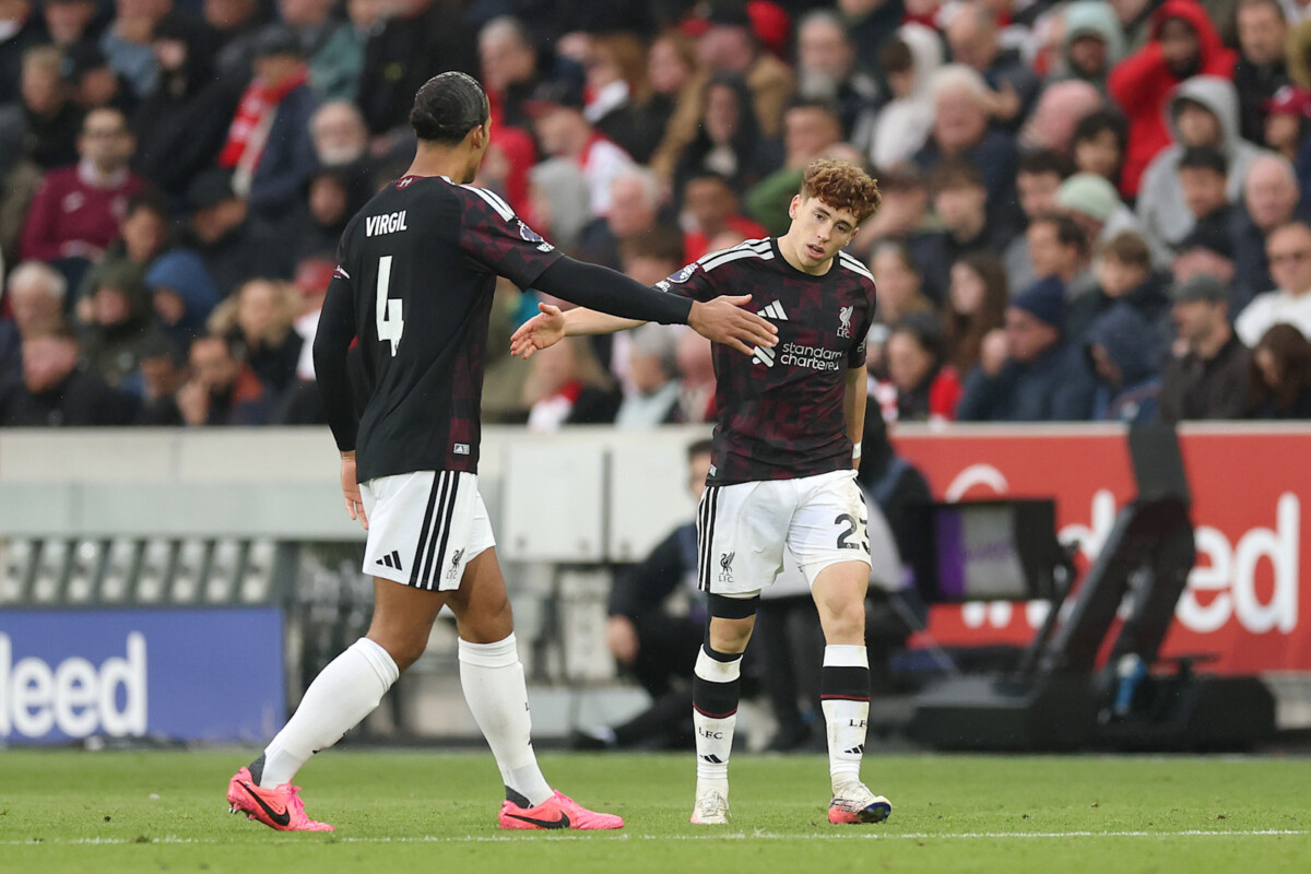 Virgil van Dijk greets a Liverpool team-mate on the pitch at Gtech Community Stadium against Brentford