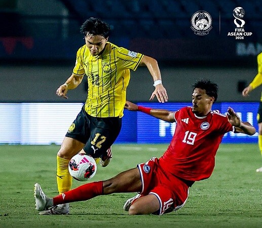 Malaysia and Singapore players challenge for the ball in the Lions ASEAN Cup match in Bandung