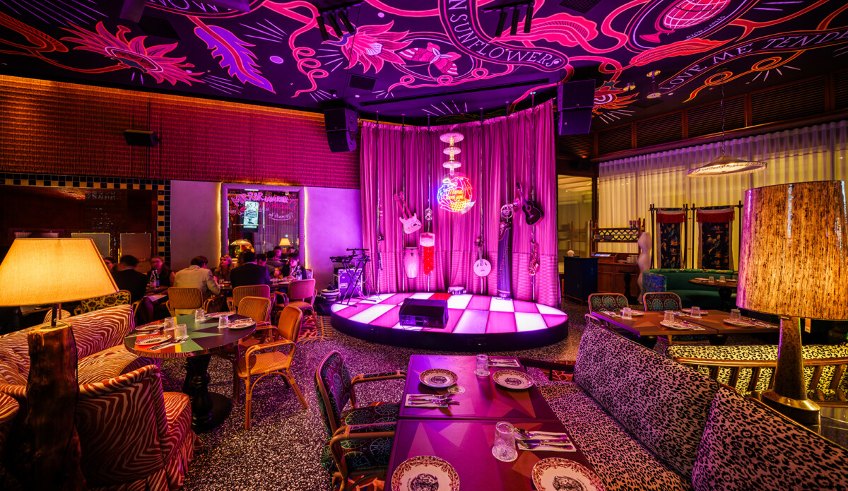 Mama Restaurant dining room at Mama Shelter Singapore with stage, patterned banquettes and painted ceiling