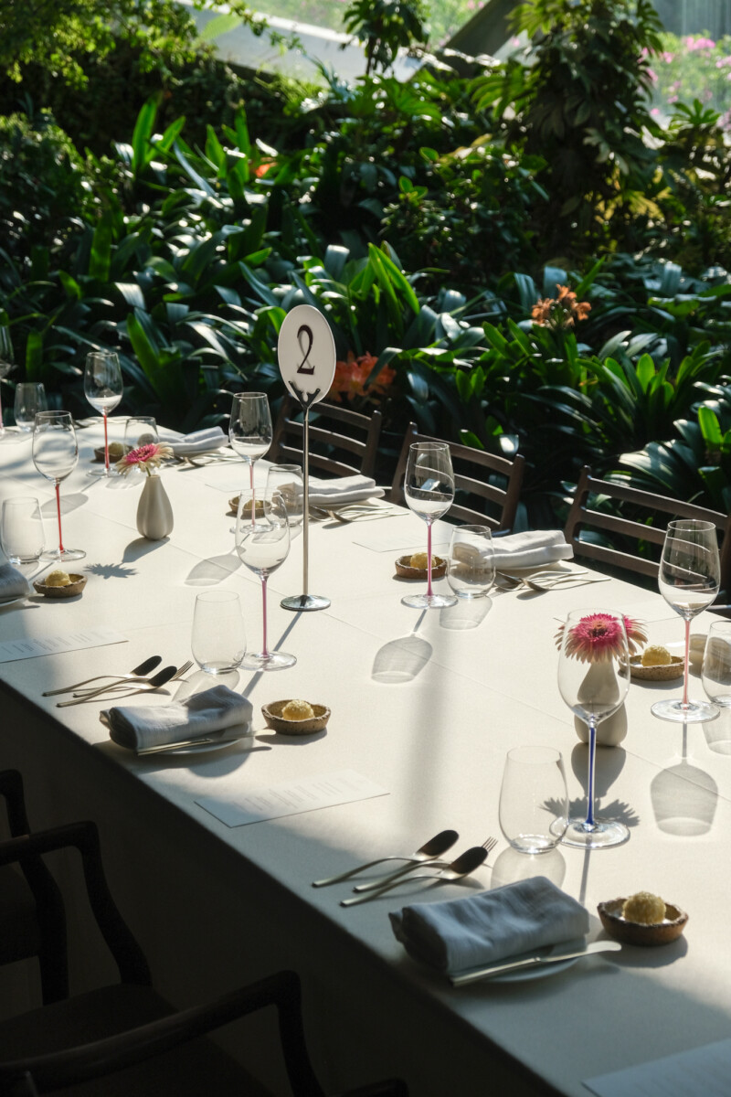 Marguerite restaurant table setting with tropical garden backdrop