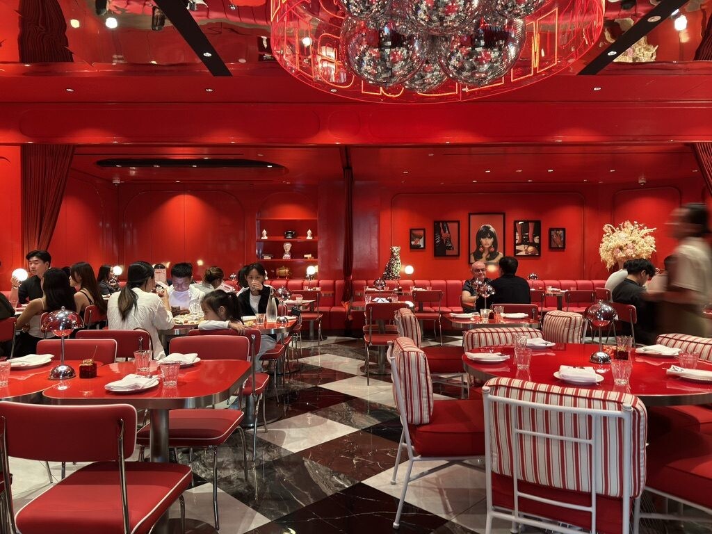Disco balls above the red dining room at Medusa Osteria Romana Singapore