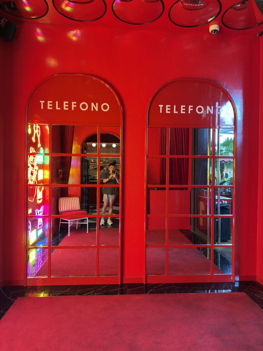 Mirrored Telefono phone booth doors in red at Medusa Osteria Romana