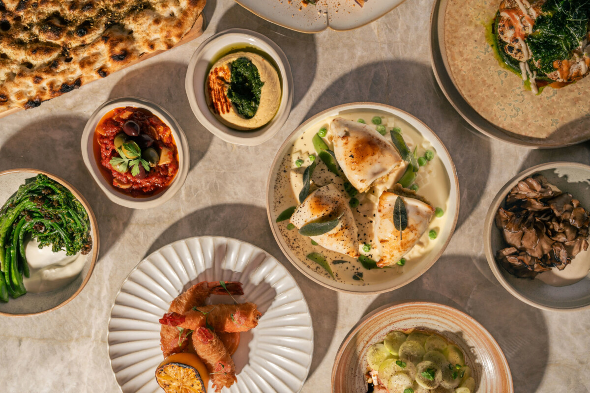 Petra mezze dips, flatbread, salads and seafood dishes laid out on a stone table