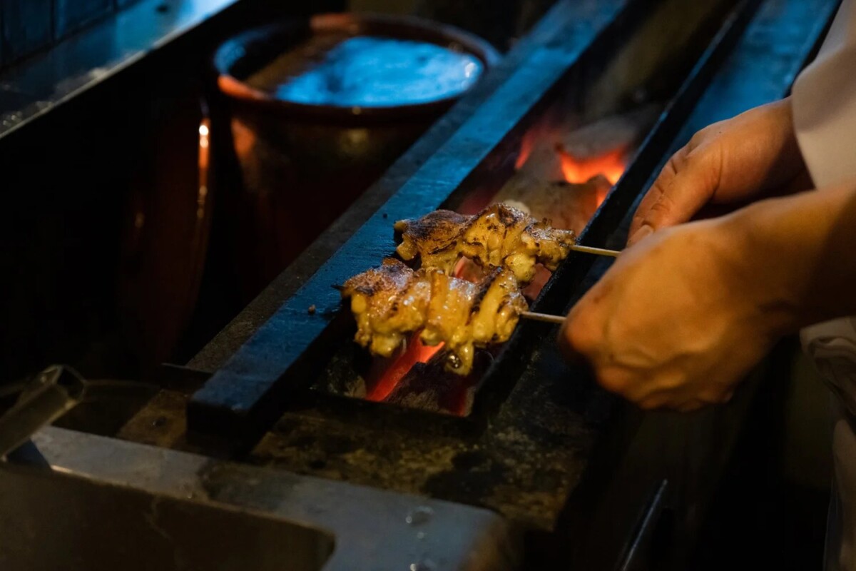 Torimitsu yakitori skewers grilling over charcoal for the Tanuki Raw pop-up