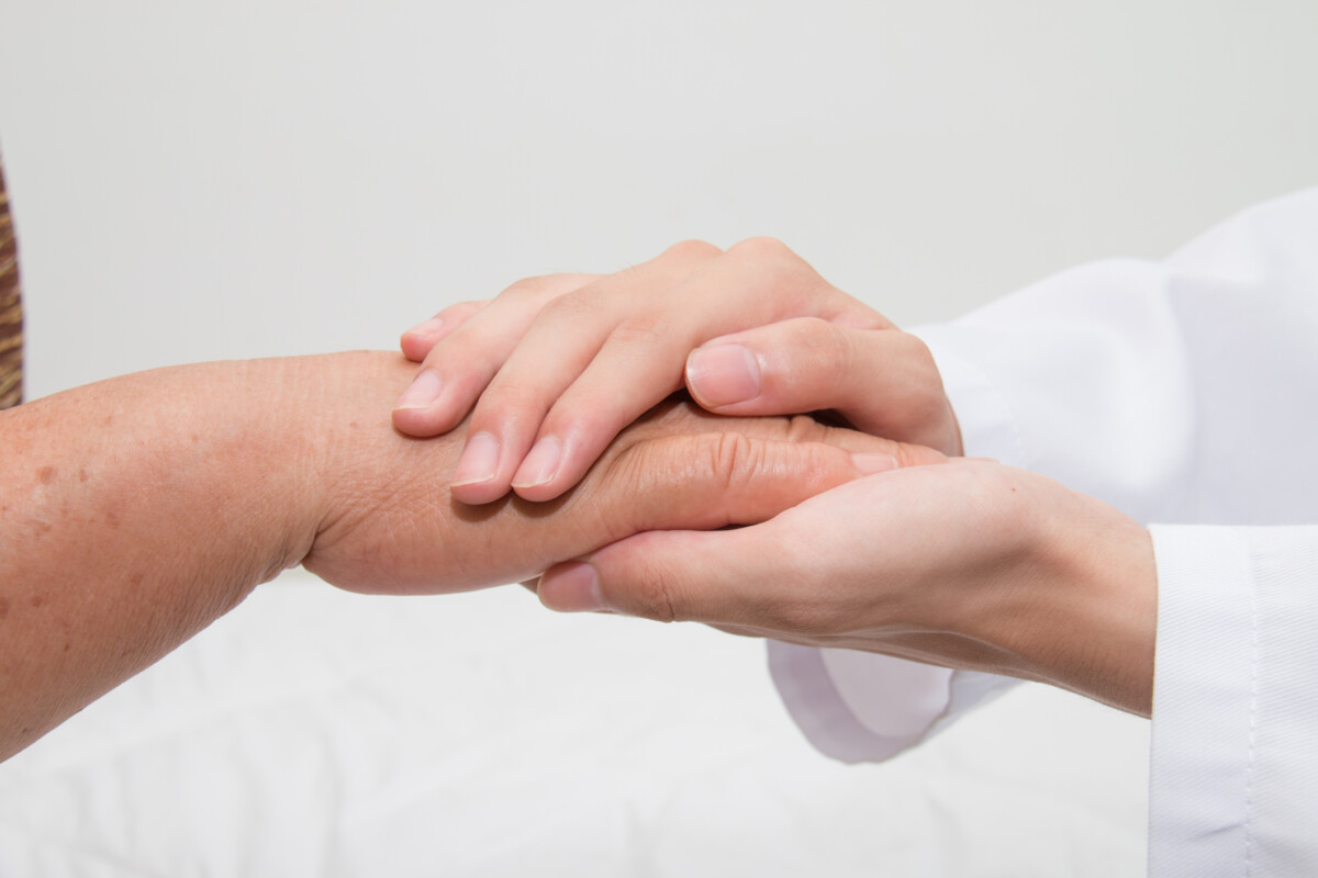 Hands offering support, representing mental health help available in Singapore