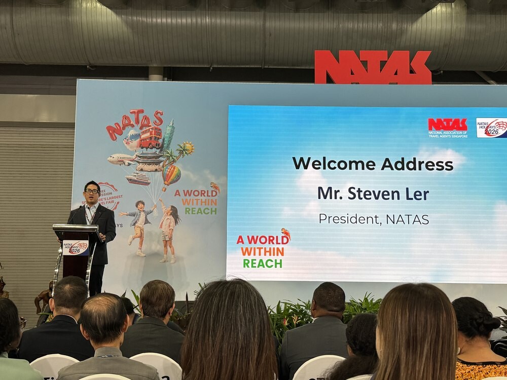 NATAS President Mr Steven Ler delivering the welcome address at a podium, with a screen reading Welcome Address Mr Steven Ler President NATAS