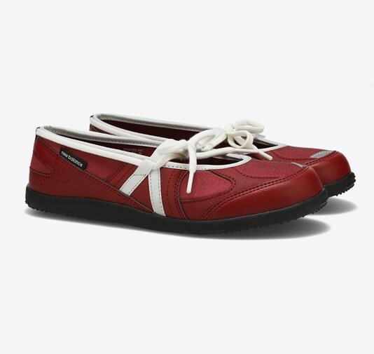 Pair of red New Balance Flat Breeze flats with white laces and sporty bands