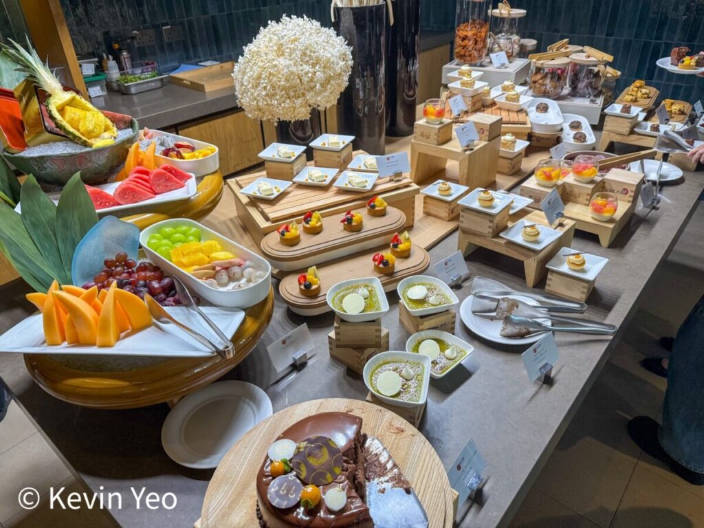 Dessert and fruit table with chocolate moist cake and sesame puffs