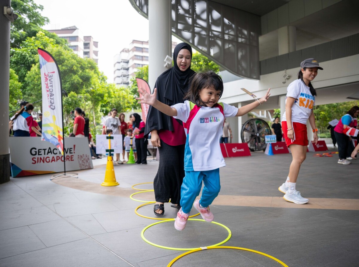 A parent guides her child through a movement station at GetActive! Singapore. Image: Sport Singapore