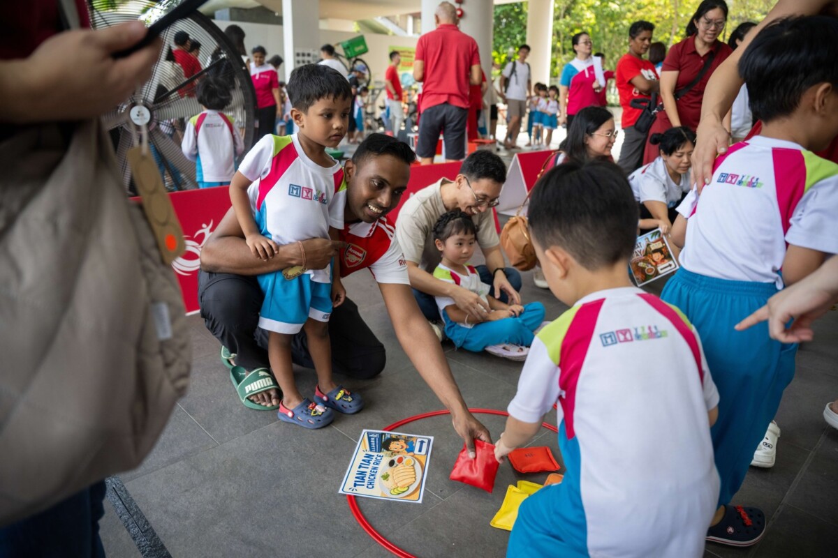 Children try multigenerational games such as five stones and bean bags. Image: Sport Singapore