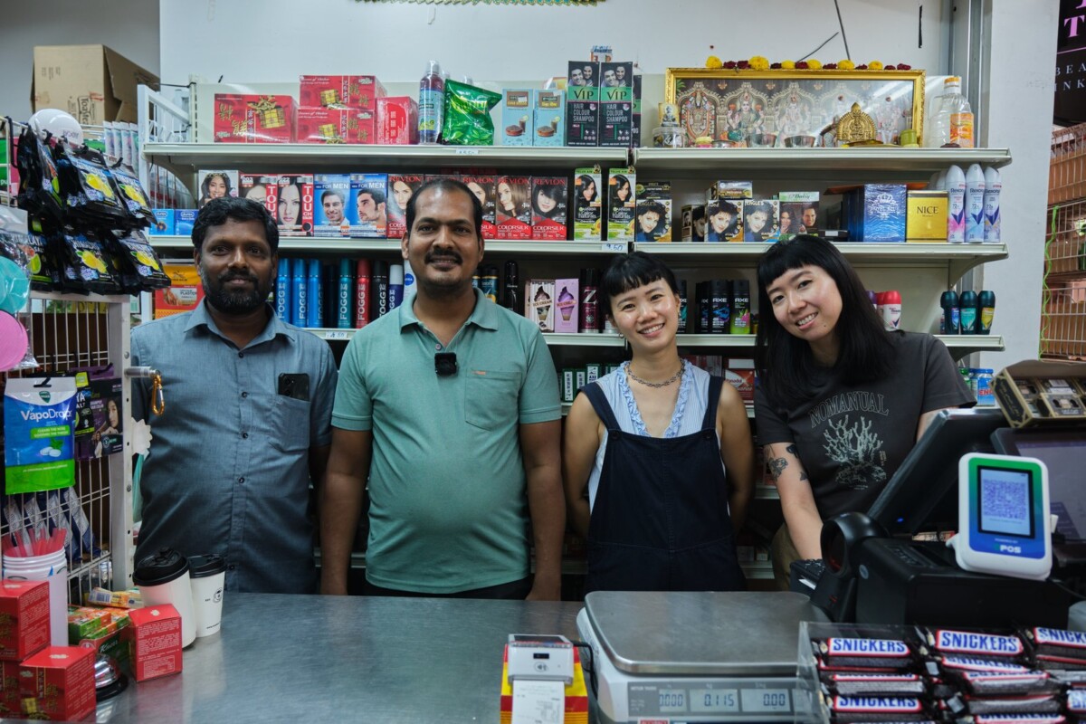 Artists Genevieve Ang and Woong Soak Teng on cashier duty at Hoseh Global Minimart