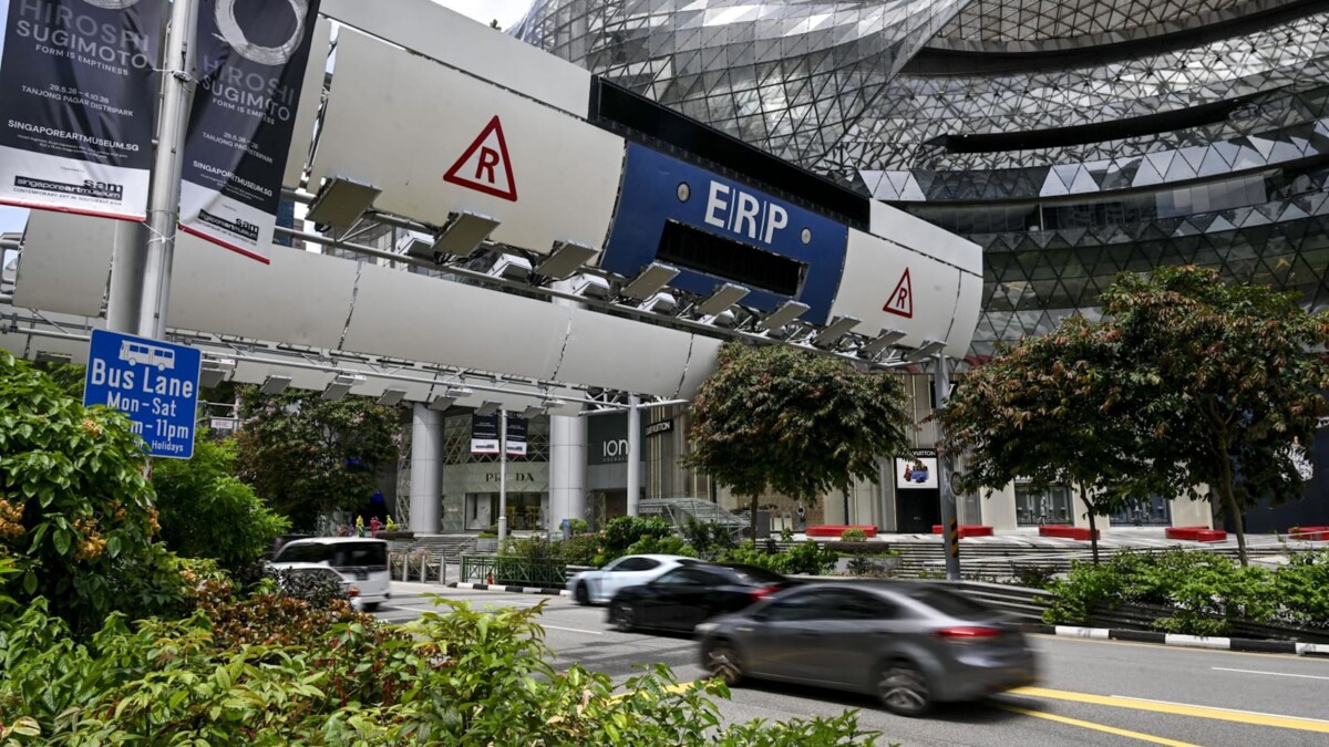 Cars drive through an ERP gantry along Orchard Road near ION Orchard