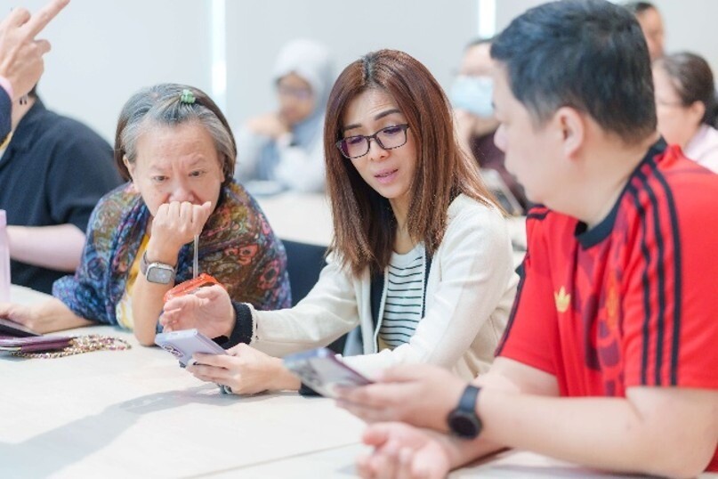 Residents learning to use AI tools on their phones at a course at Buangkok Community Club
