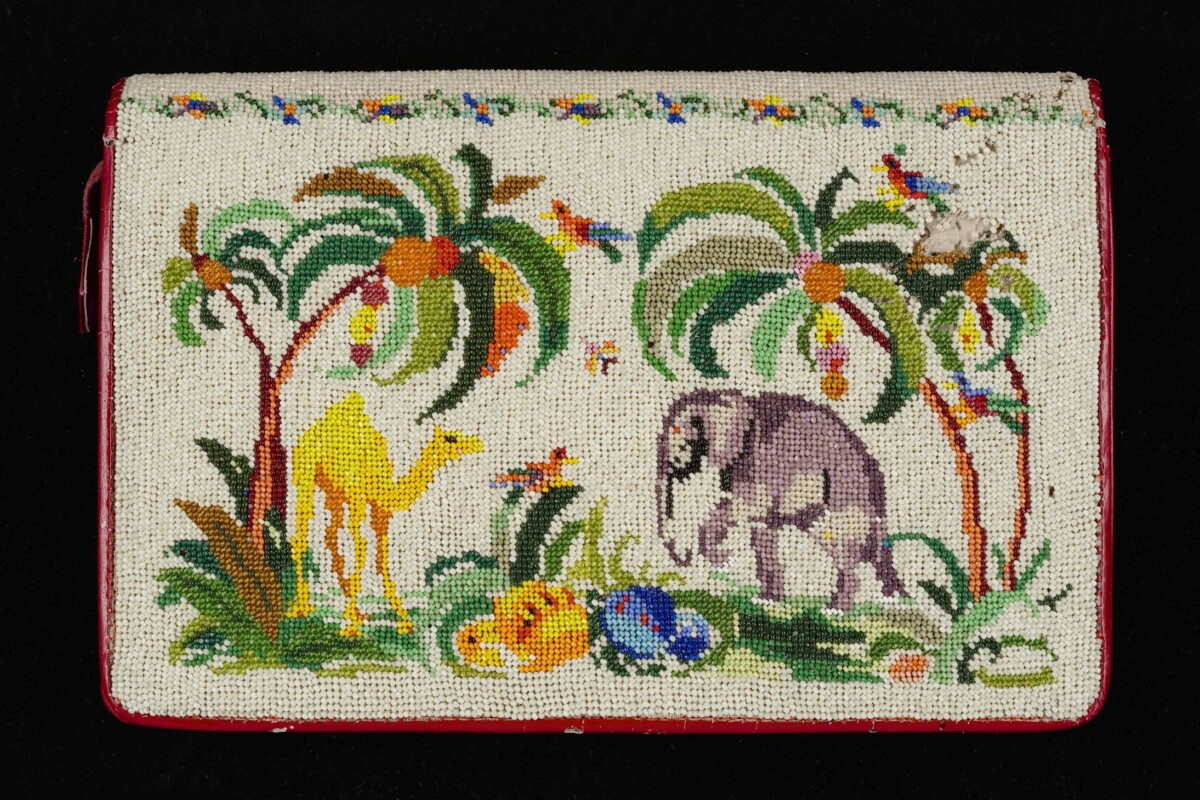 Beaded clutch purse by Alice Choo with palm trees, a camel and an elephant