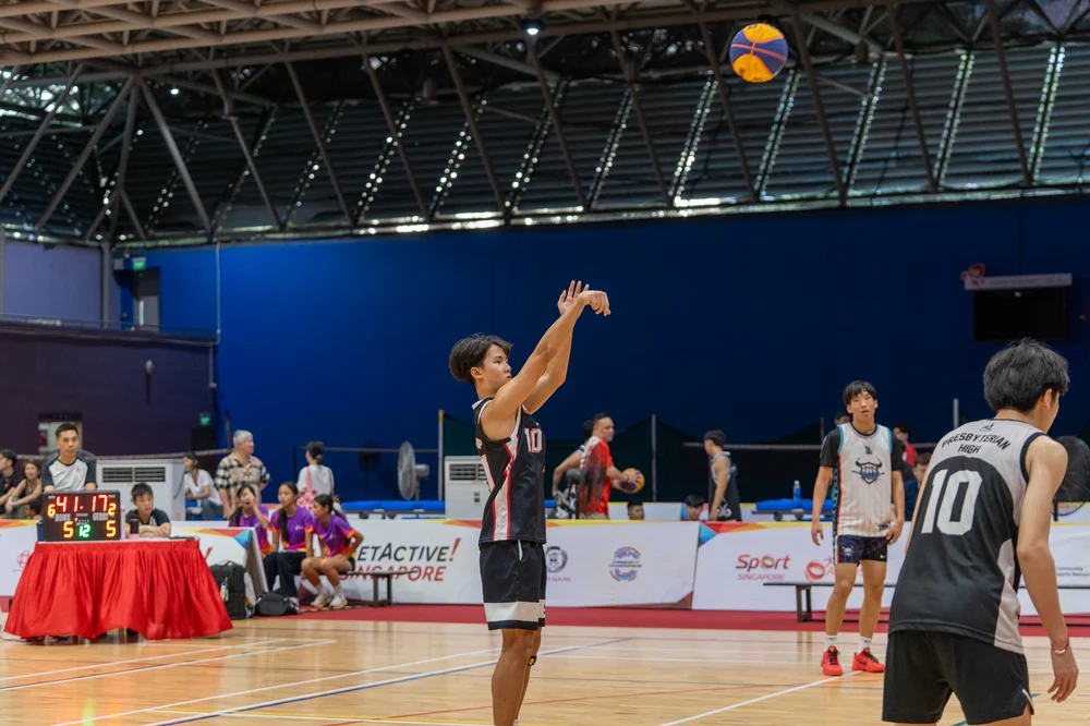 Basketball players shooting during the Pesta Sukan Community Championship