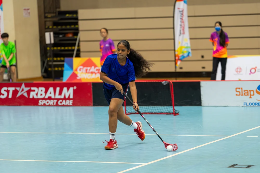 Floorball player dribbling during the Pesta Sukan Community Championship