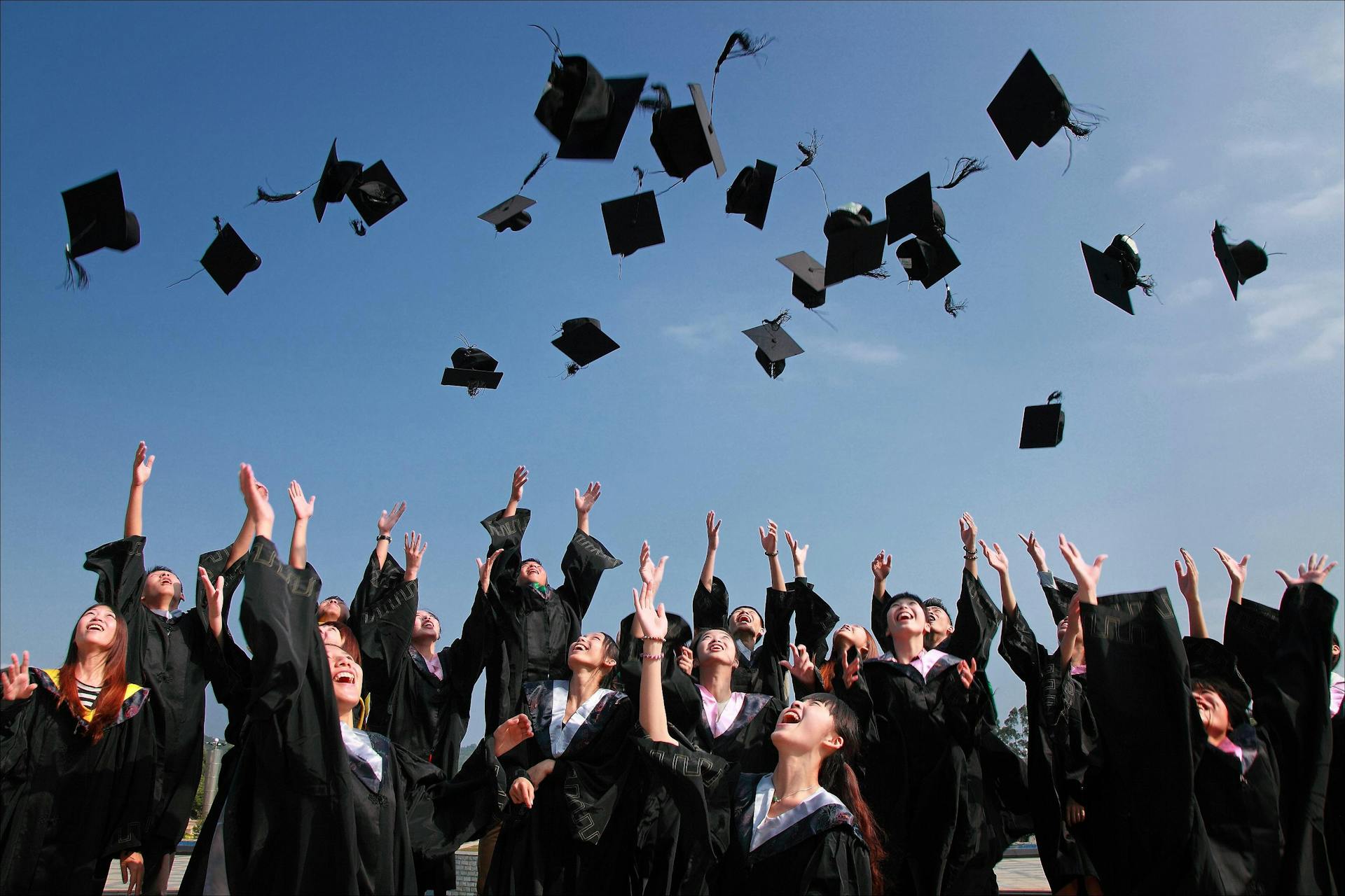University graduates in Singapore celebrating at commencement ceremony