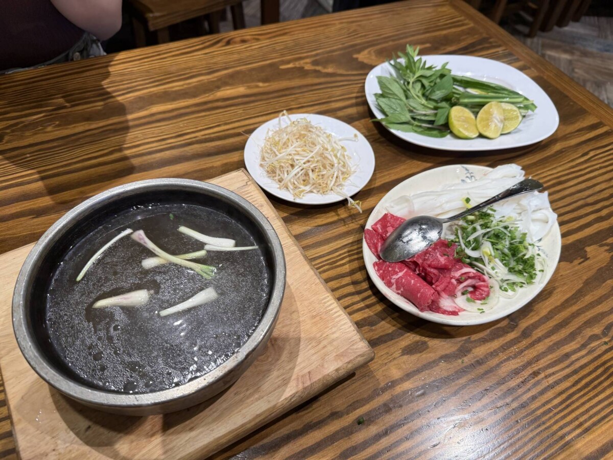 Wagyu meat hotpot at Pho Vietnam Saigon served with hot stone broth, raw wagyu, herbs and lime