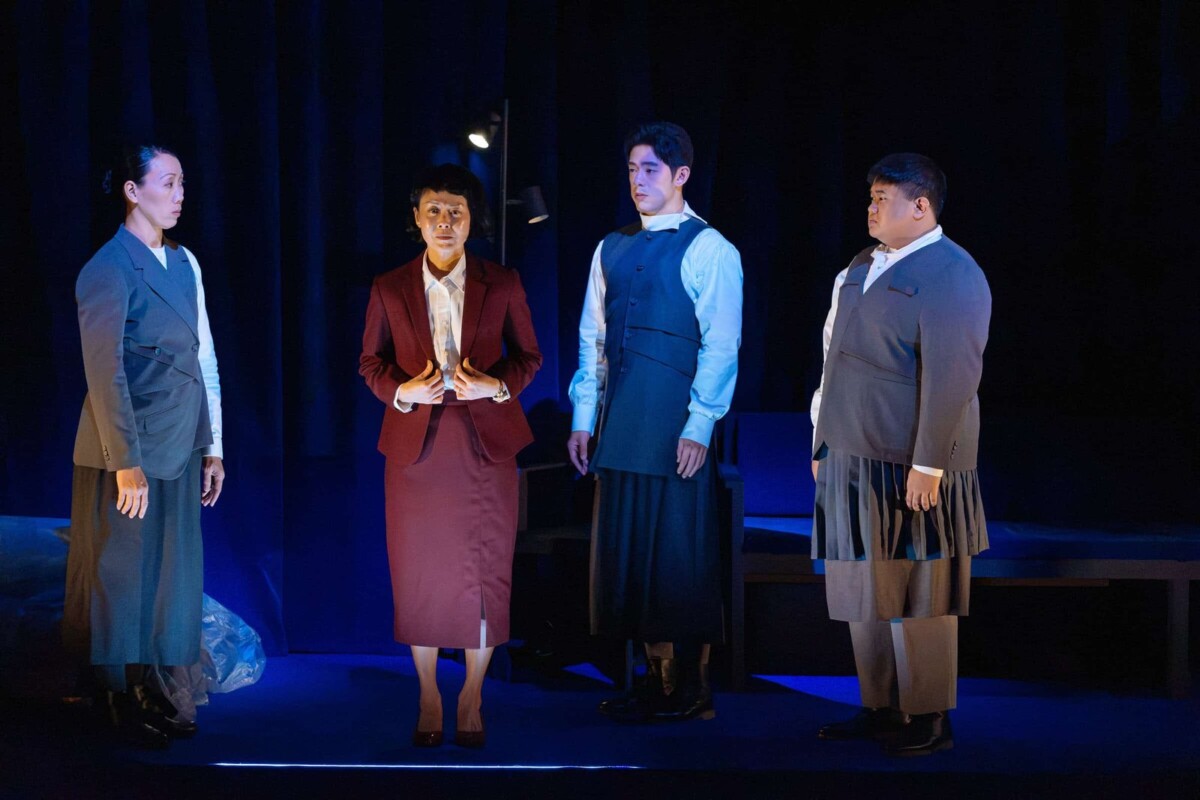 Scene from The Radicalisation of Mrs. Mary Lim-Rodrigues with the principal in red and students