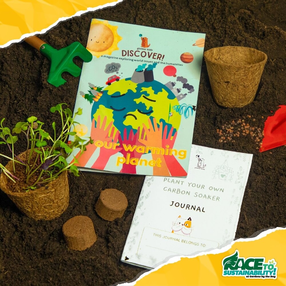 Our Warming Planet booklet, journal, coir pots and microgreens laid out on soil
