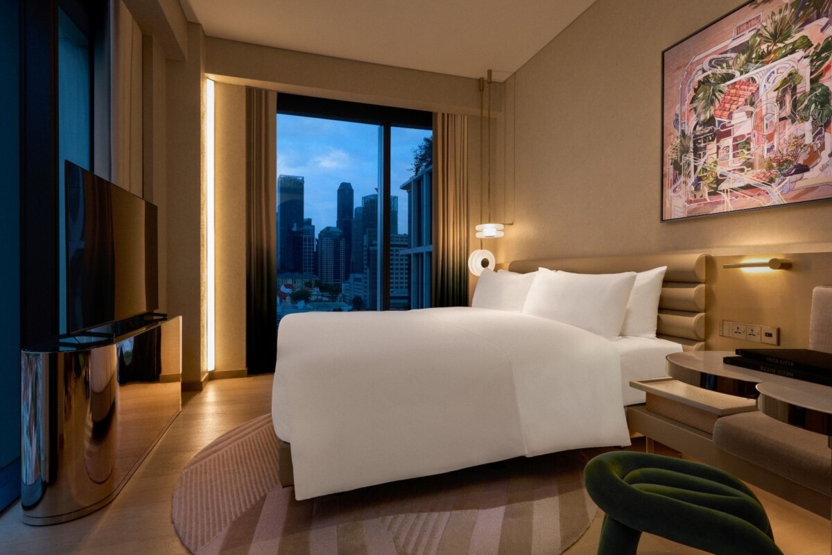 Signature Corner room with king bed and city skyline view at Mondrian Singapore Duxton