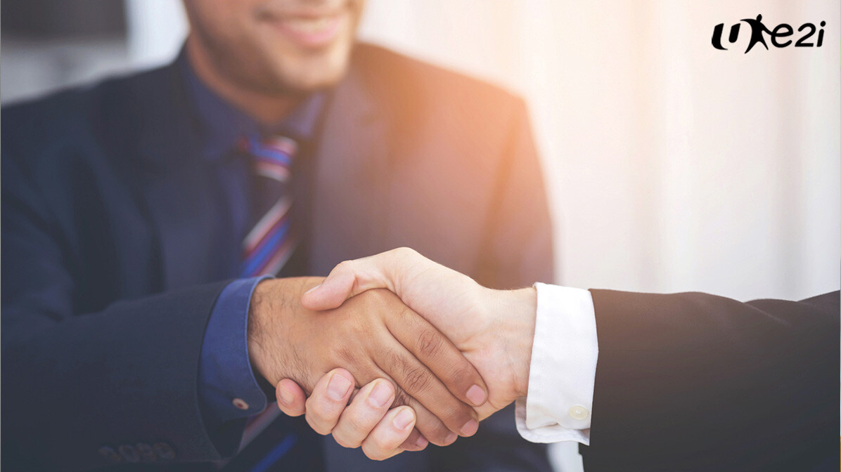Two professionals shaking hands after a job placement in Singapore
