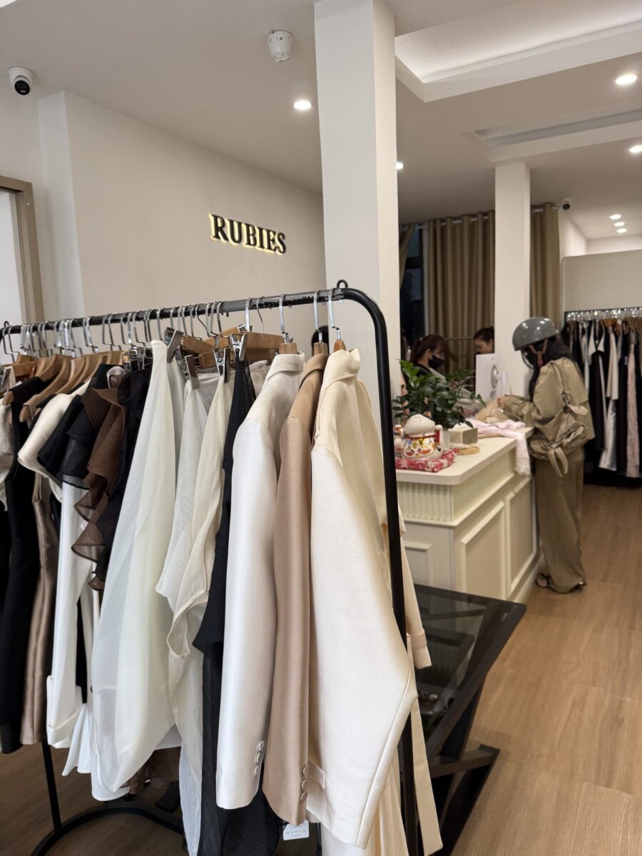 Inside Ruby's boutique on Tran Quang Dieu street, Saigon, with soft satin and silk pieces in cream, beige and black tones