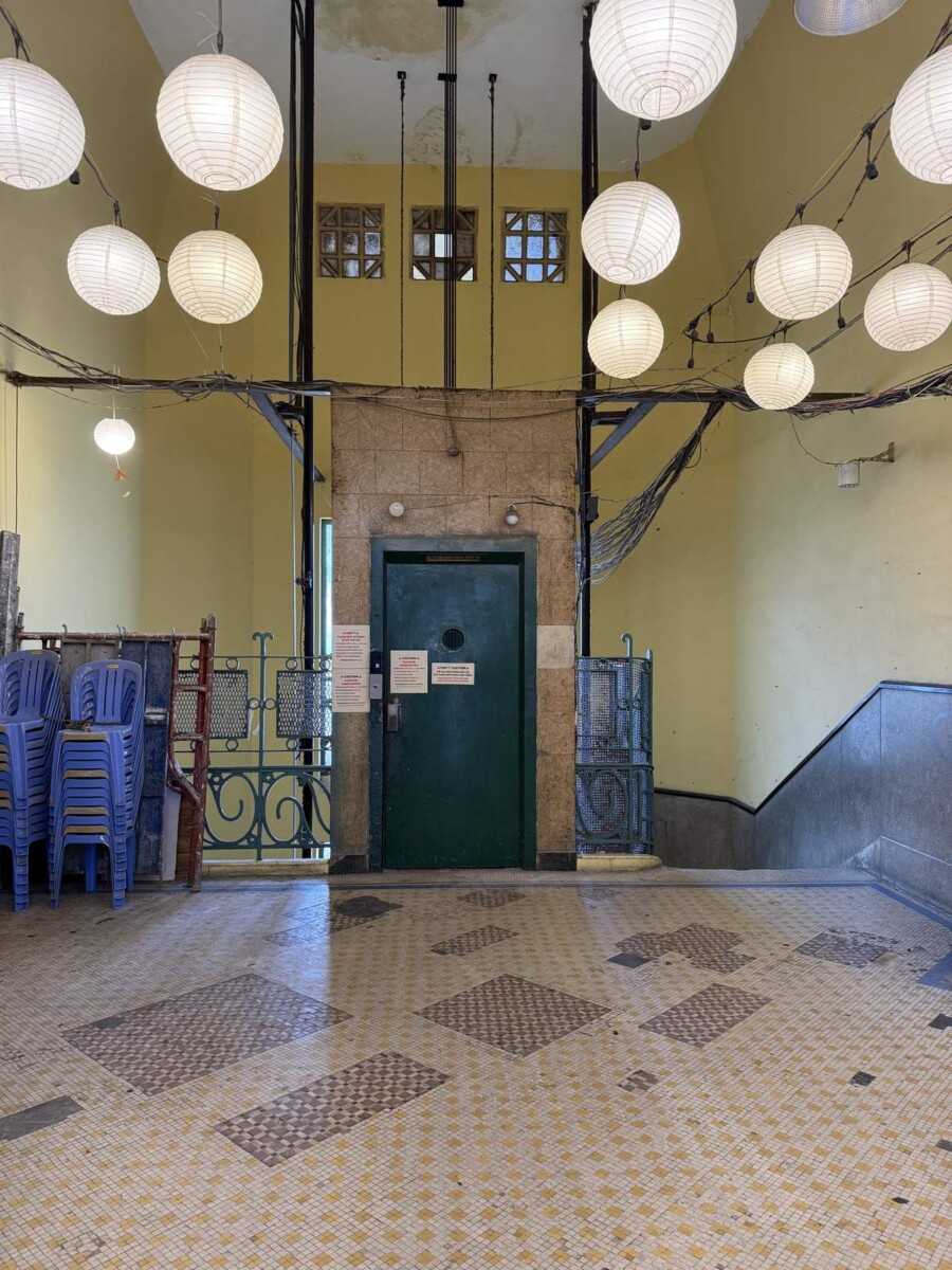 Top floor of 26 Ly Tu Trong, Saigon, with paper lanterns, an old elevator door and original mosaic tiles