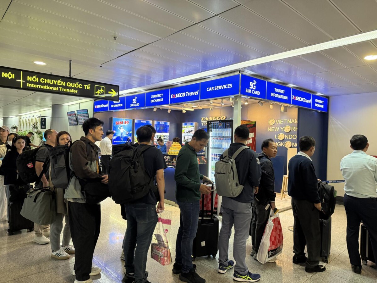 TASECO kiosk near the international transfer signage at Saigon airport, offering SIM cards, currency exchange and tourist information