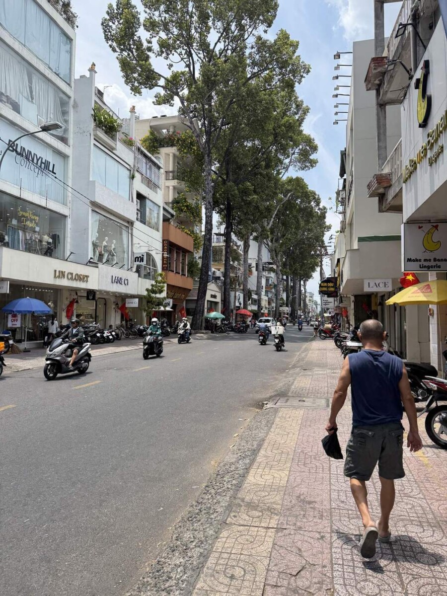 Typical view down a Saigon boutique shopping street, with bikes parked along the pavements
