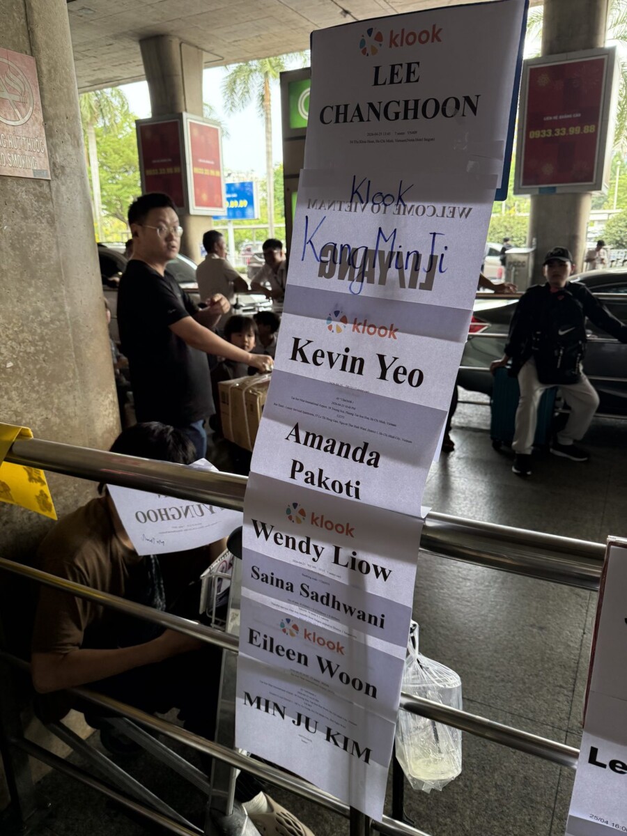 Klook fast-track name papers pasted at column 9 of Saigon airport pickup area