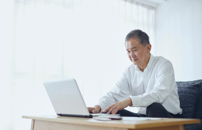 Mid-career man studying at a laptop