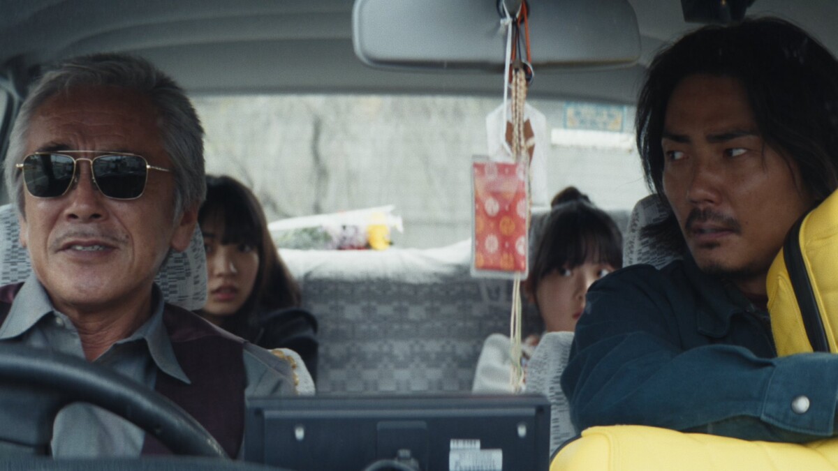 Still from the Japanese family film The Invisibles showing passengers in a taxi