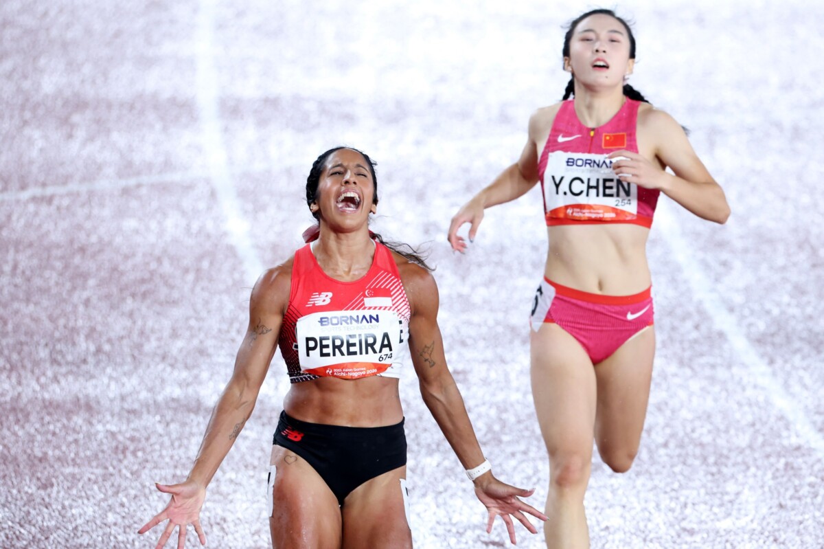 Shanti Pereira screams in celebration at the finish as China's Chen Yujie runs behind