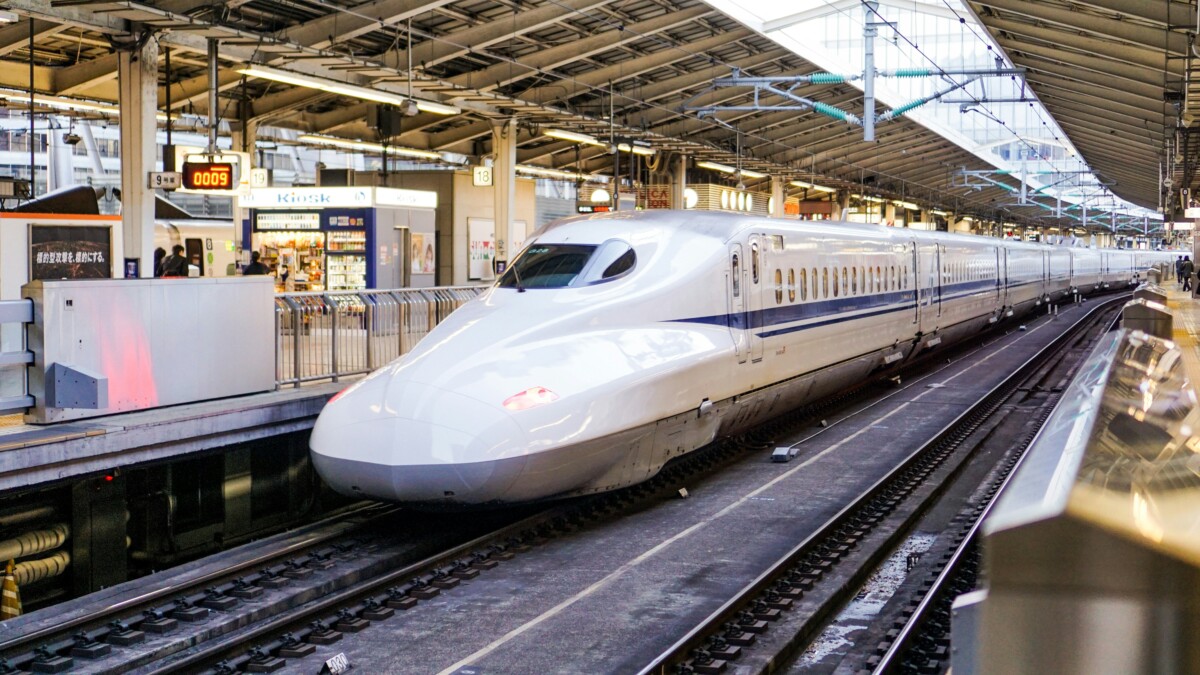 A Japan Rail Shinkansen bullet train waiting at a station platform in Japan