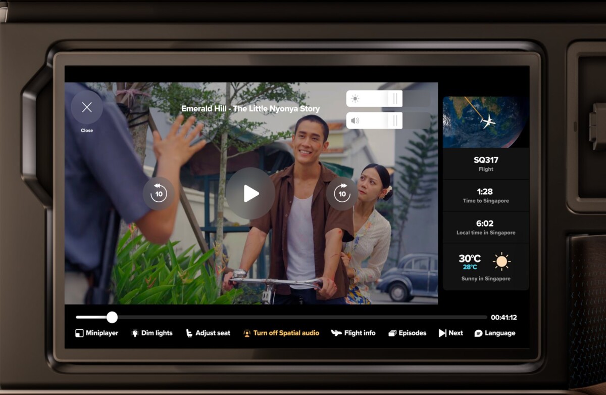 KrisWorld screen playing a film with a flight information sidebar showing time to destination and weather