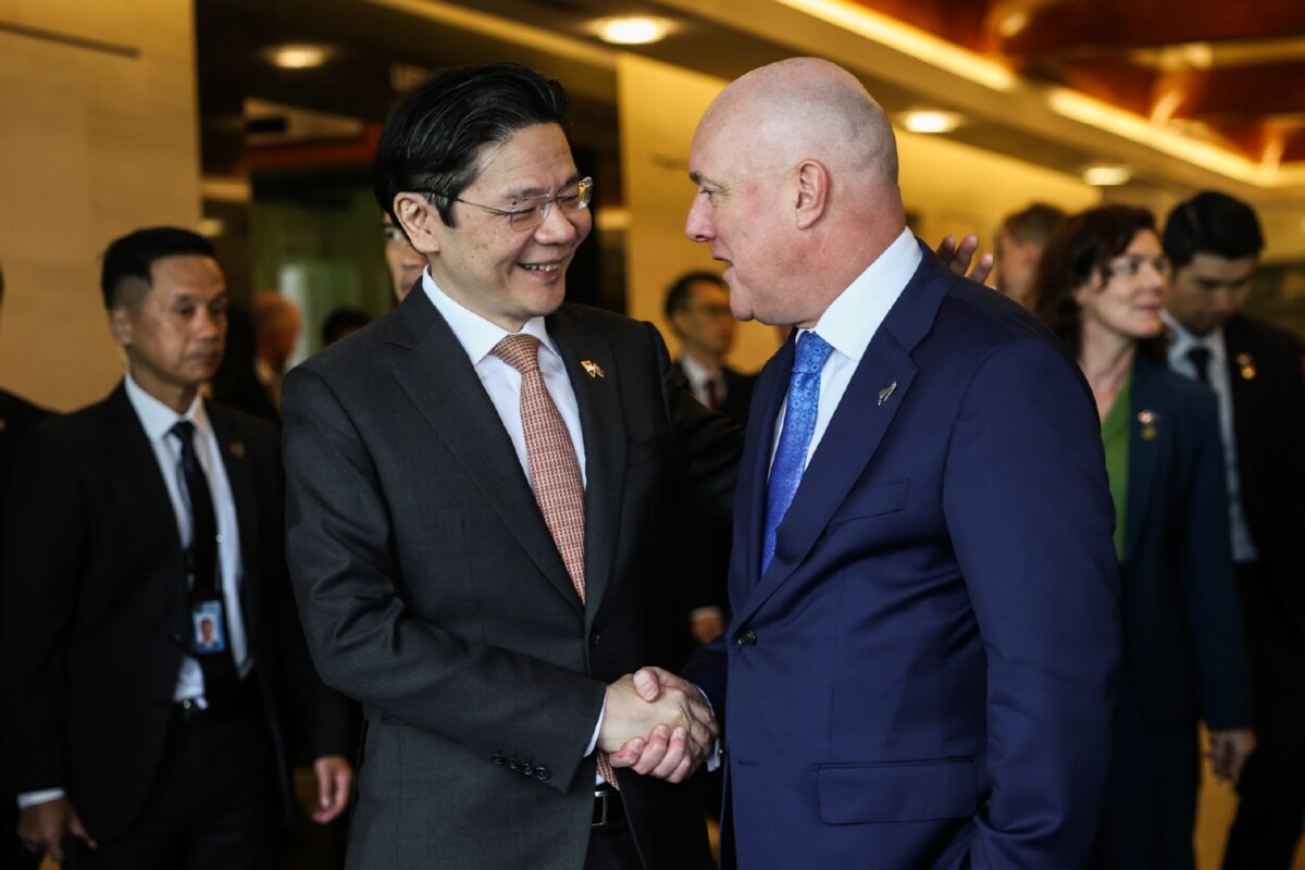 Singapore-New Zealand essential supplies pact leaders handshake
