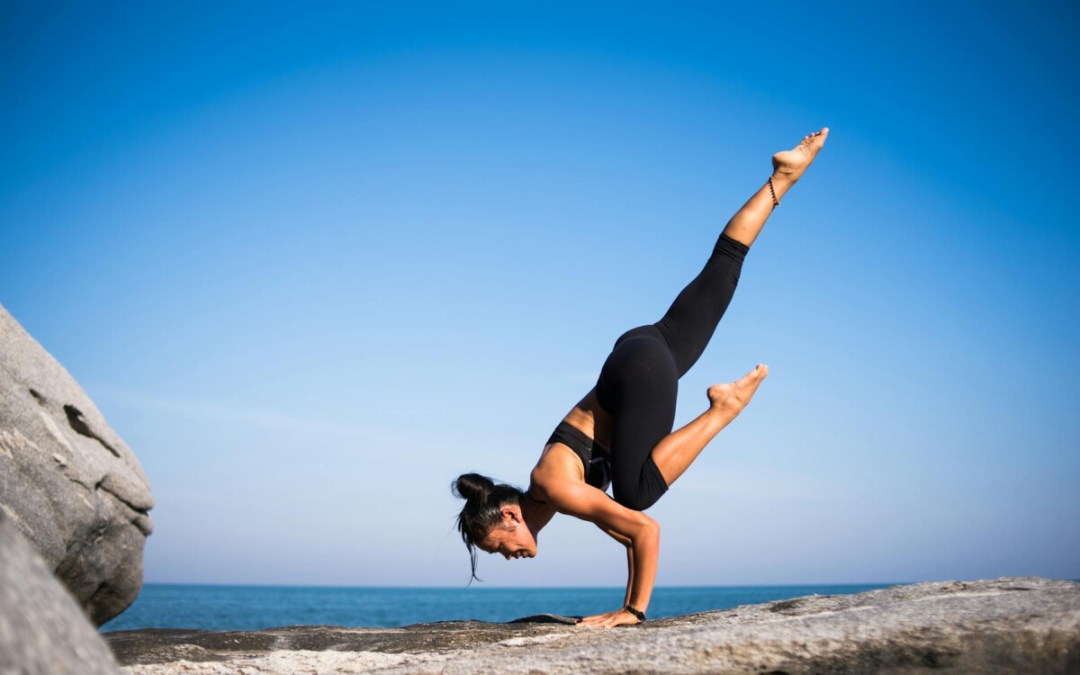 Person practising yoga outdoors in a peaceful park setting