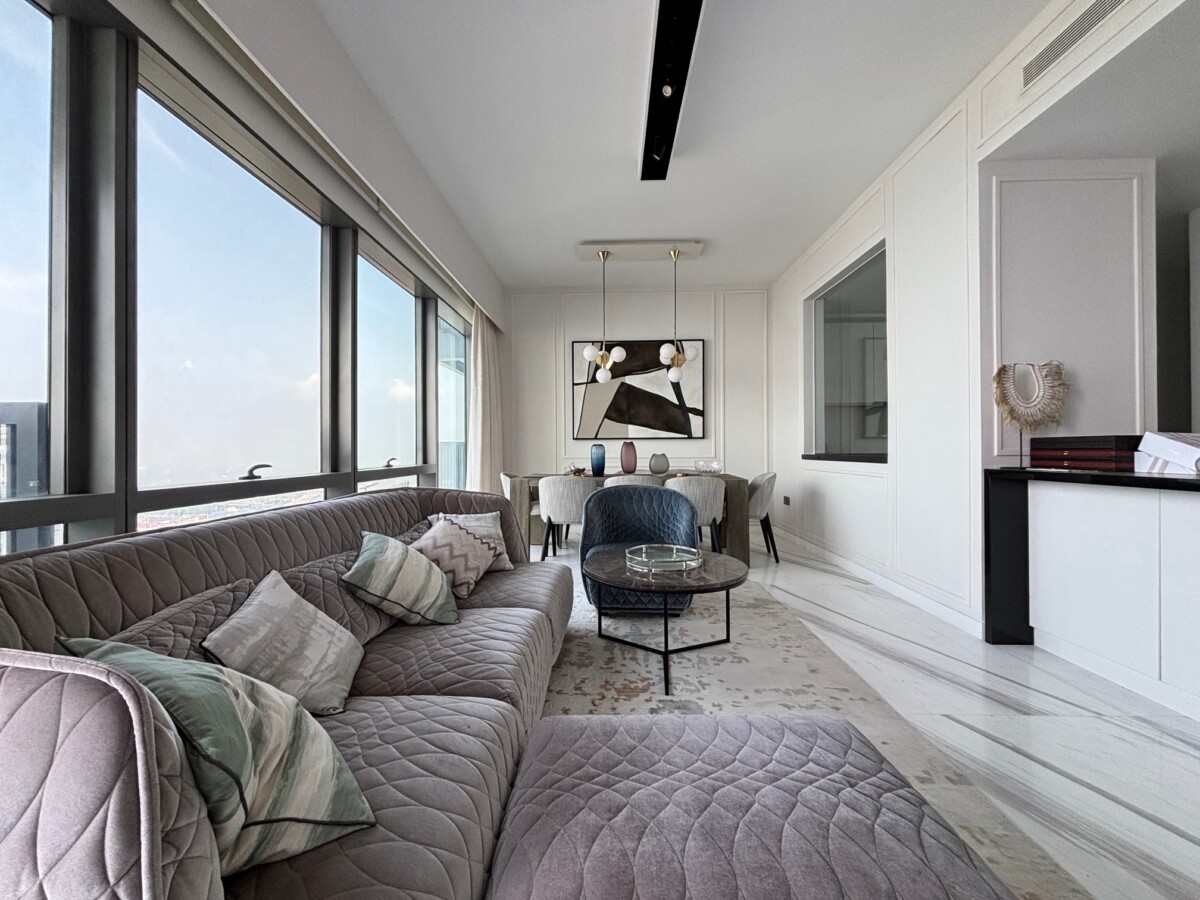 Furnished luxury living and dining room with city view windows