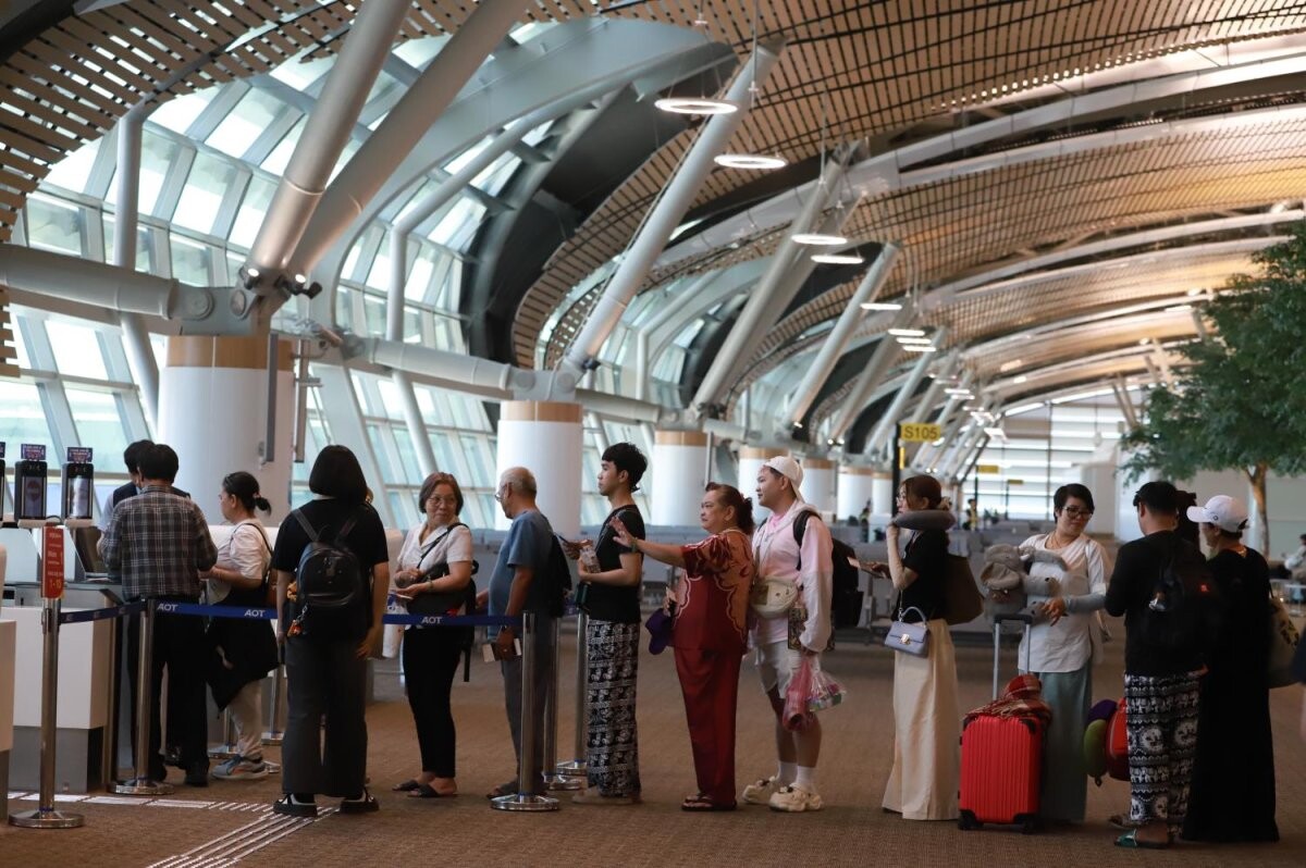 Travellers queueing to board a flight at Suvarnabhumi Airport in Bangkok
