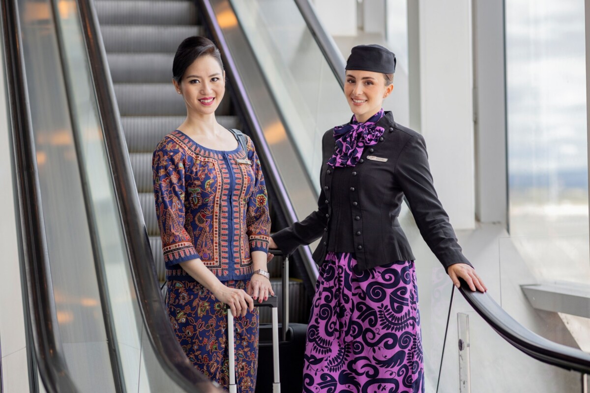 Tail fins of an Air New Zealand aircraft and a Singapore Airlines aircraft side by side