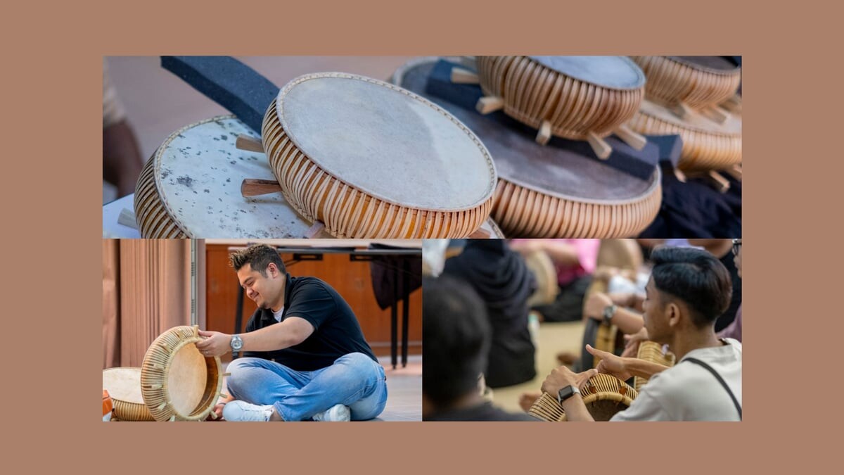 Rebana drums stacked together with visitors trying them out