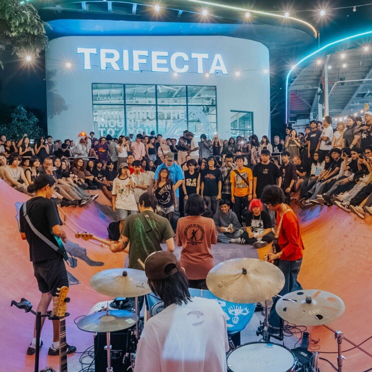 Band playing to a crowd in The Bowl skate bowl at TRIFECTA, Somerset