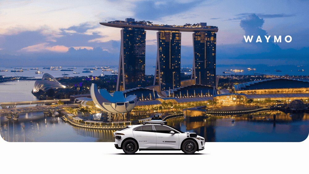 Waymo Jaguar I-PACE autonomous vehicle shown against a Singapore Marina Bay backdrop