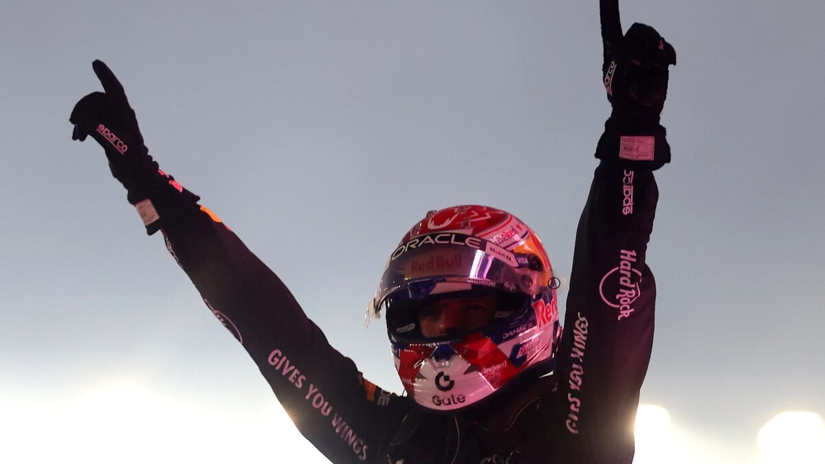 Max Verstappen raises both arms in celebration after winning the 2026 Singapore Grand Prix