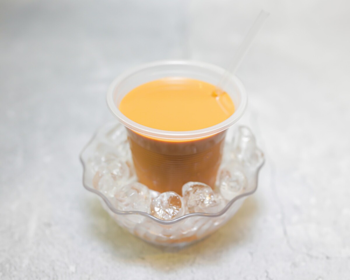HK-style iced milk tea cup chilled in a bowl of ice