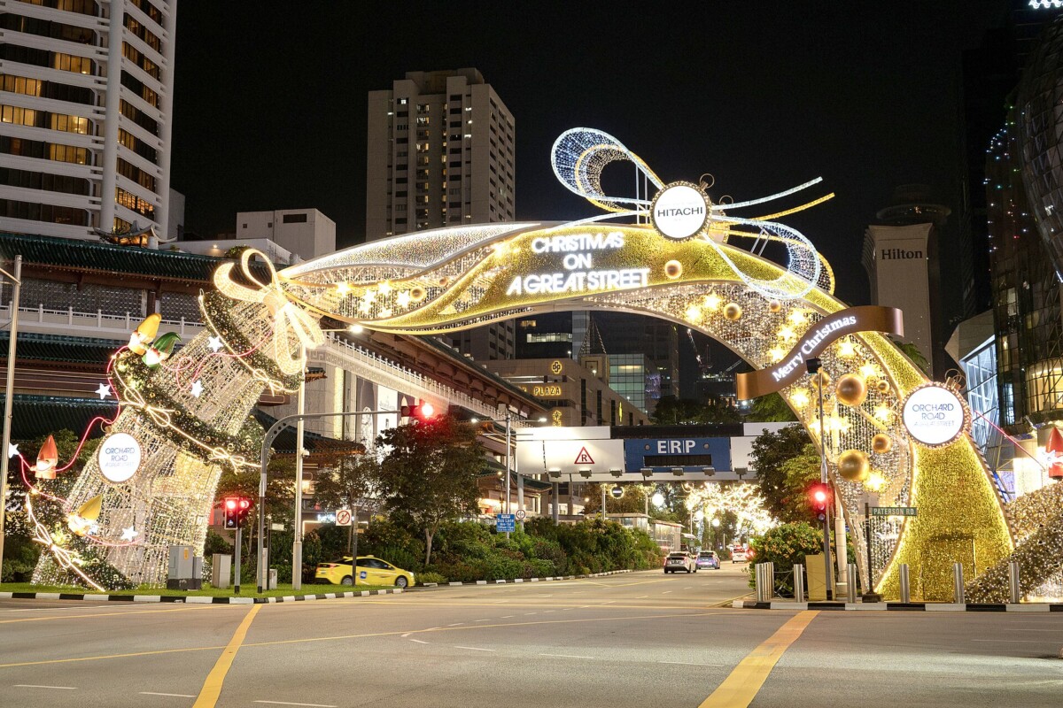Christmas on A Great Street light-up arch over Orchard Road at night